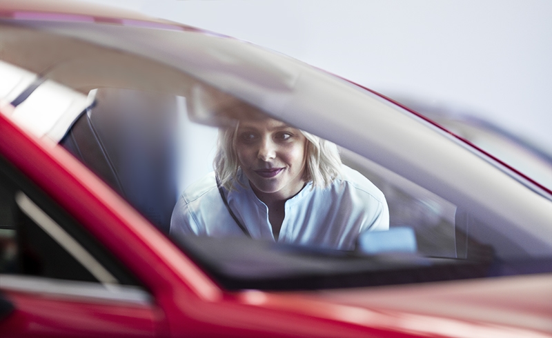 Woman enjoying new Mazda with guaranteed future value.