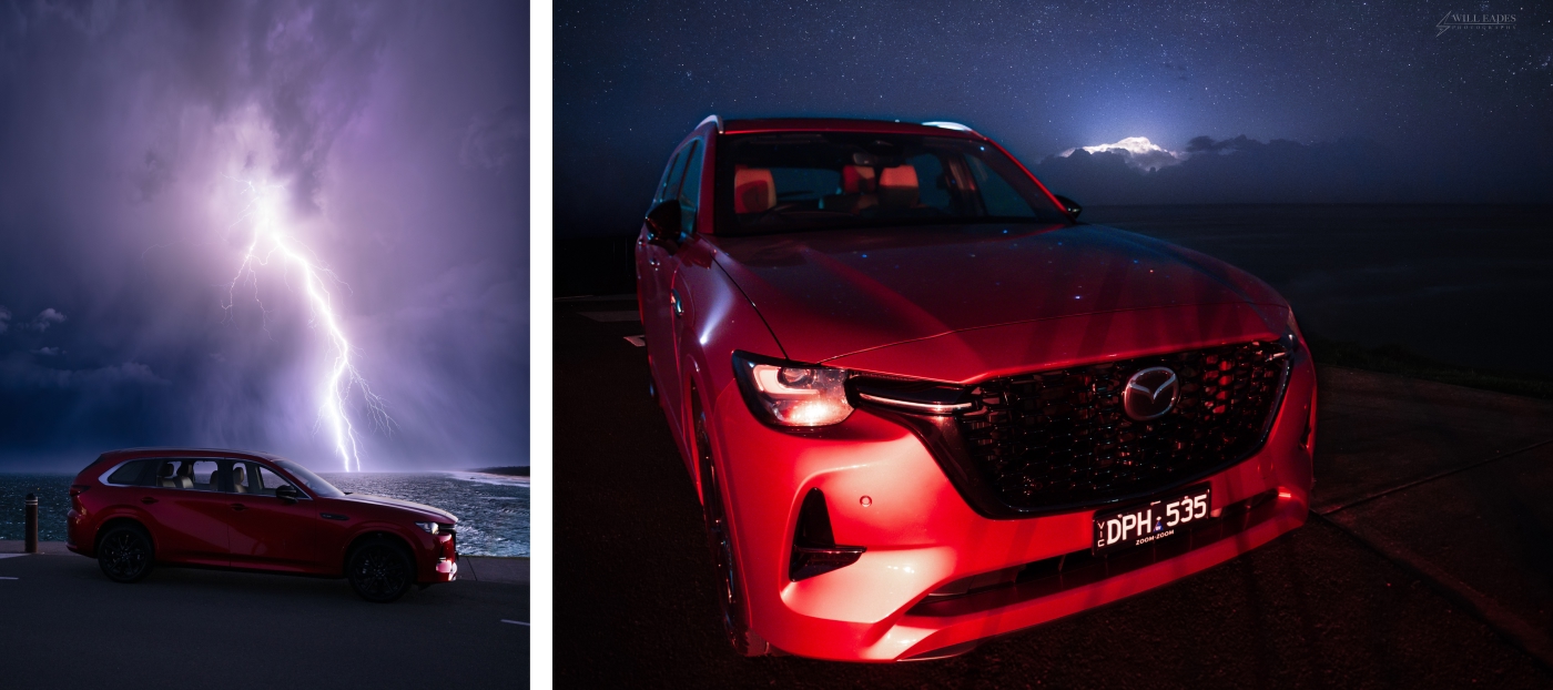 Red Mazda CX‑80 parked beside the water at night, shown alongside a dramatic lightning strike illuminating storm clouds over the ocean.