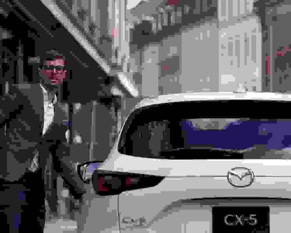 Businessman enjoying Mazda car with a chattel mortgage loan