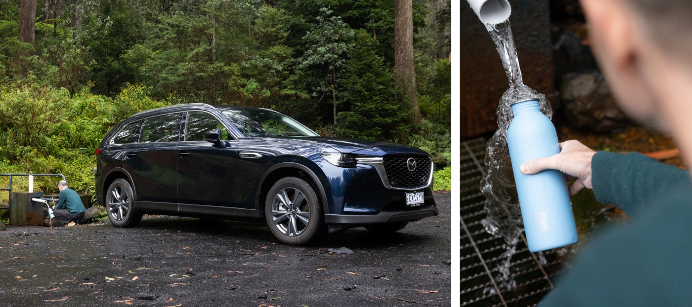 Mazda CX-80 Pure family SUV parked in lush Yarra Valley forest while water bottle is filled at roadside spring, Victoria Australia