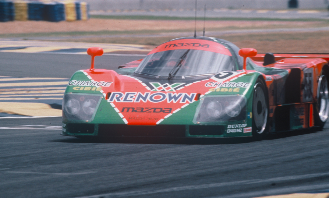 Mazda 787B No.55 in Renown livery racing on track during the 1991 Le Mans 24 Hours, showcasing the iconic rotary-powered endurance car