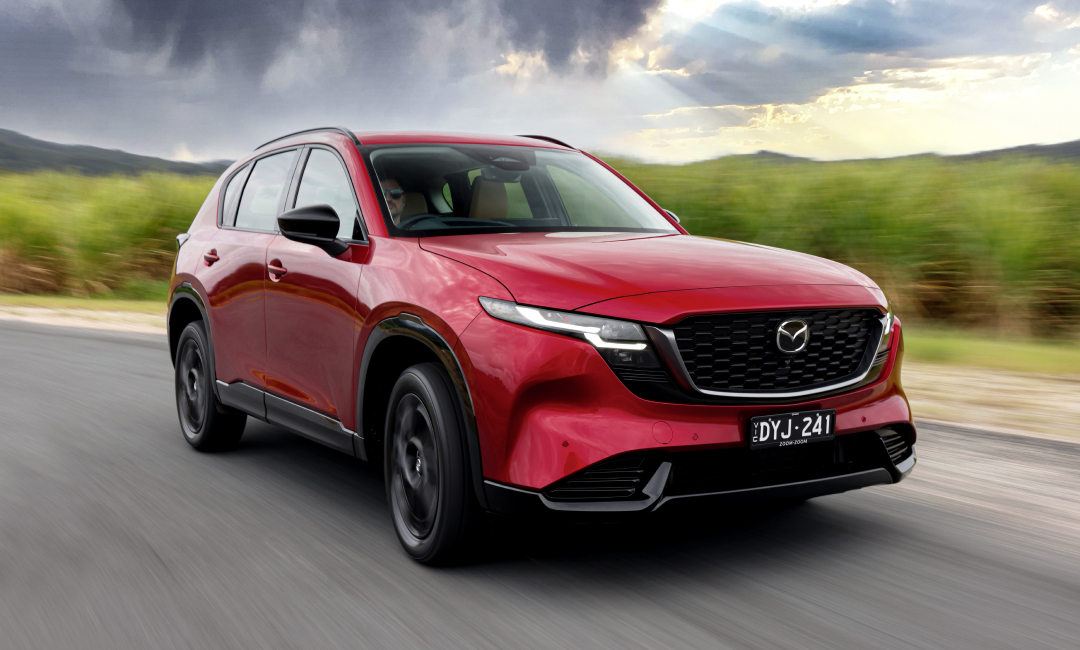 Soul Red 2026 Mazda CX-5 driving on a highway 
