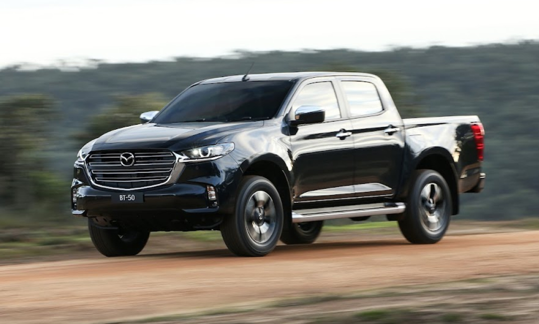 3rd Generation Mazda BT-50 four-wheel driving on a dirt road.