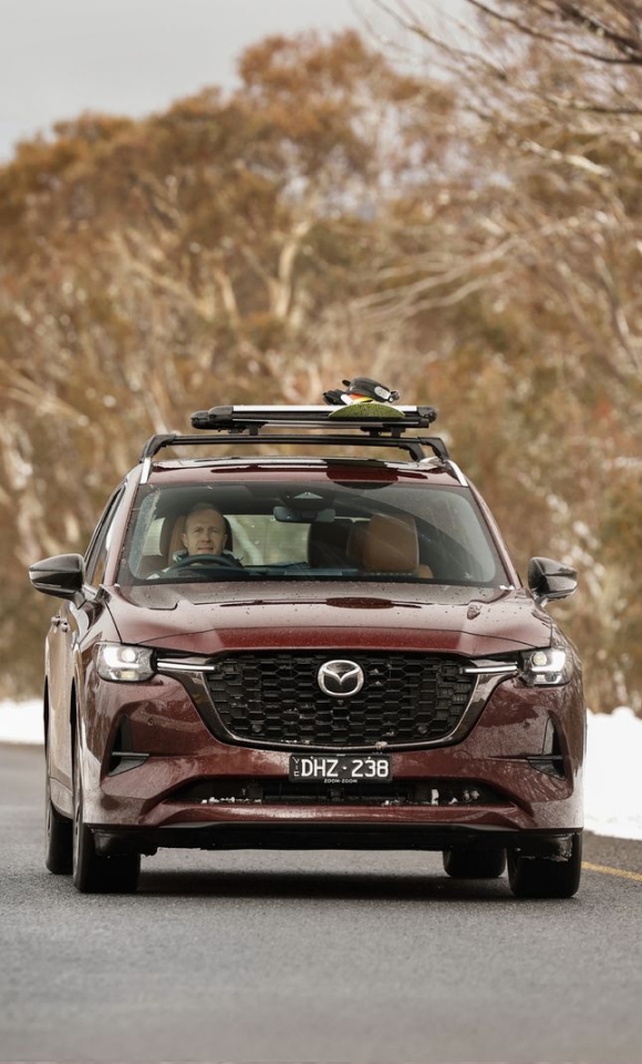 Mazda CX-80 on the snowy alpine road