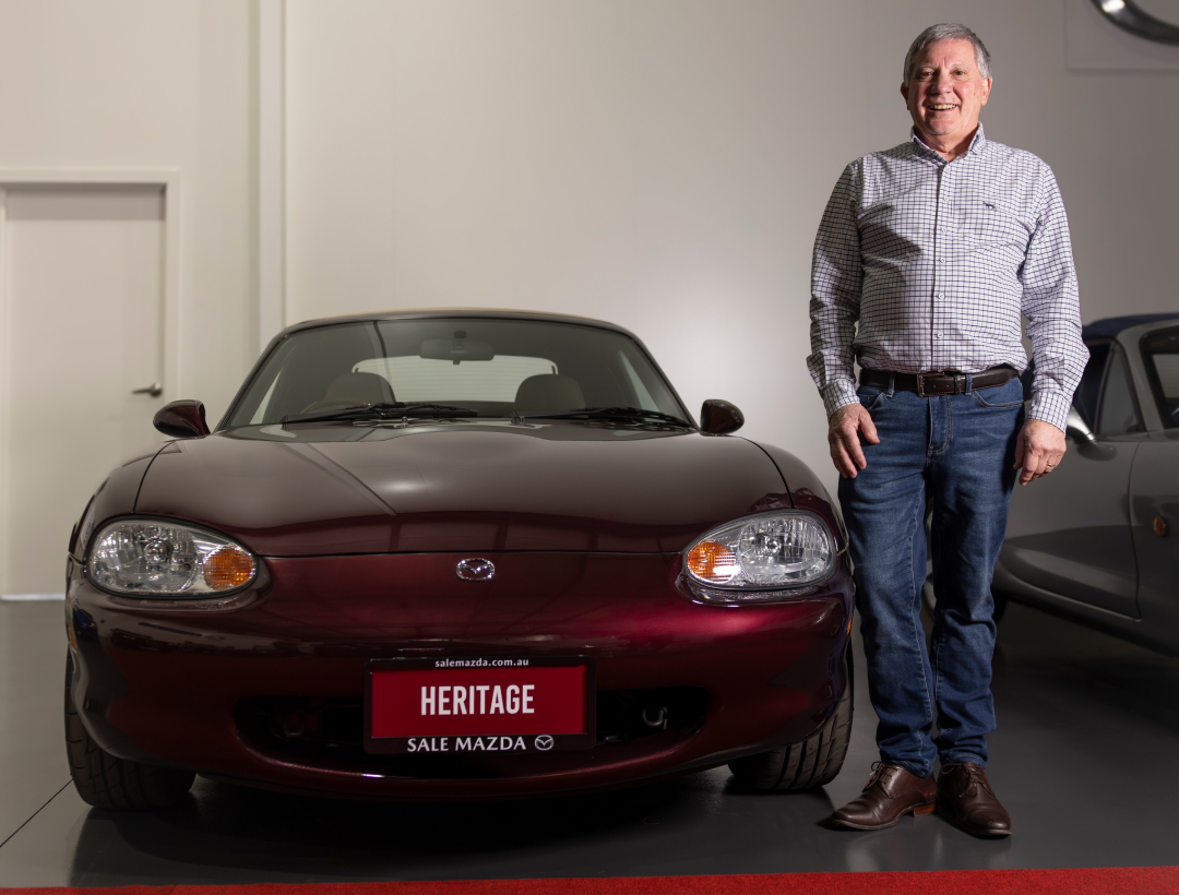 Mazda MX-5 Heritage Edition in Deep Art Vin Red Mica displayed indoors with Alan Wilson standing beside the car, part of Australia&rsquo;s greatest MX-5 collection.